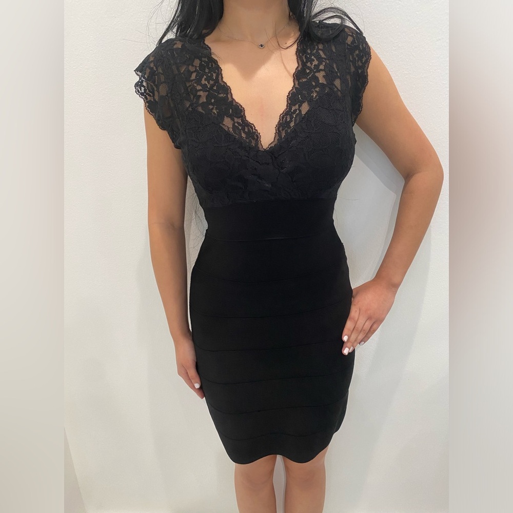 Bebe black, sleeveless, short cocktail or evening dress with
lace.